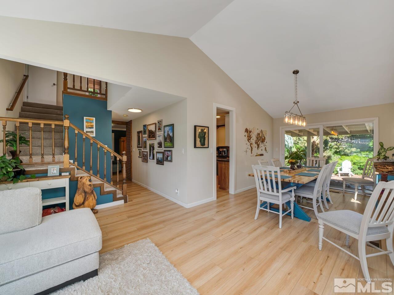 14555 Sundance Drive Reno, NV 89511 - Photo 18 of 40 a dining room with furniture a chandelier and wooden floor