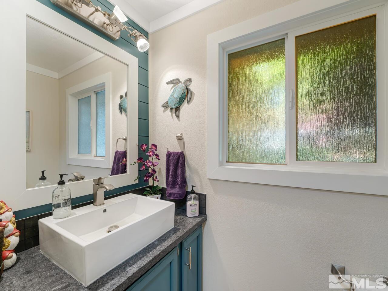 14555 Sundance Drive Reno, NV 89511 - Photo 23 of 40 a bathroom with a sink and a mirror