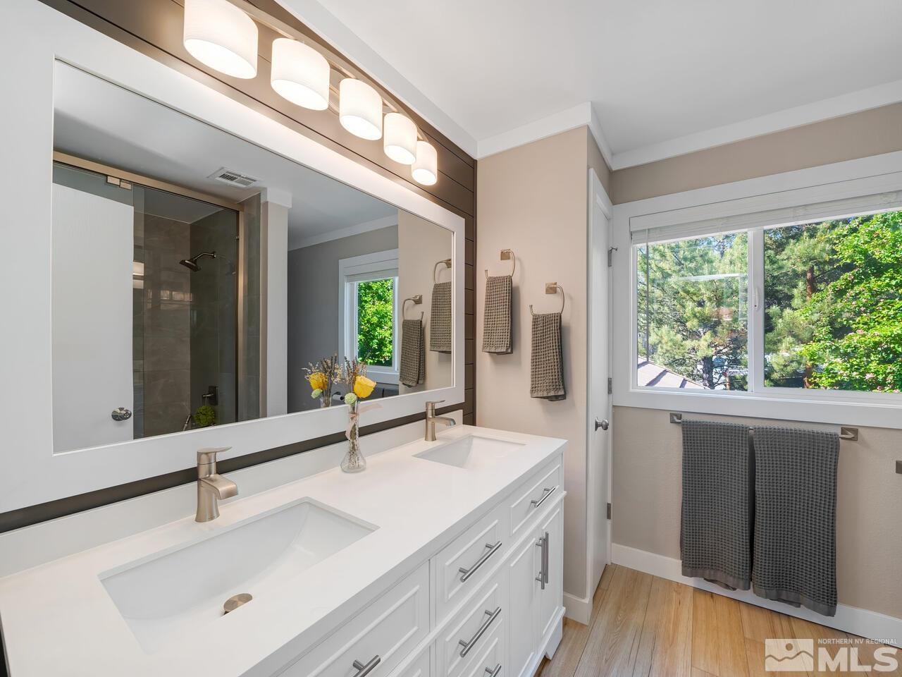 14555 Sundance Drive Reno, NV 89511 - Photo 27 of 40 a bathroom with a double vanity sink and mirror