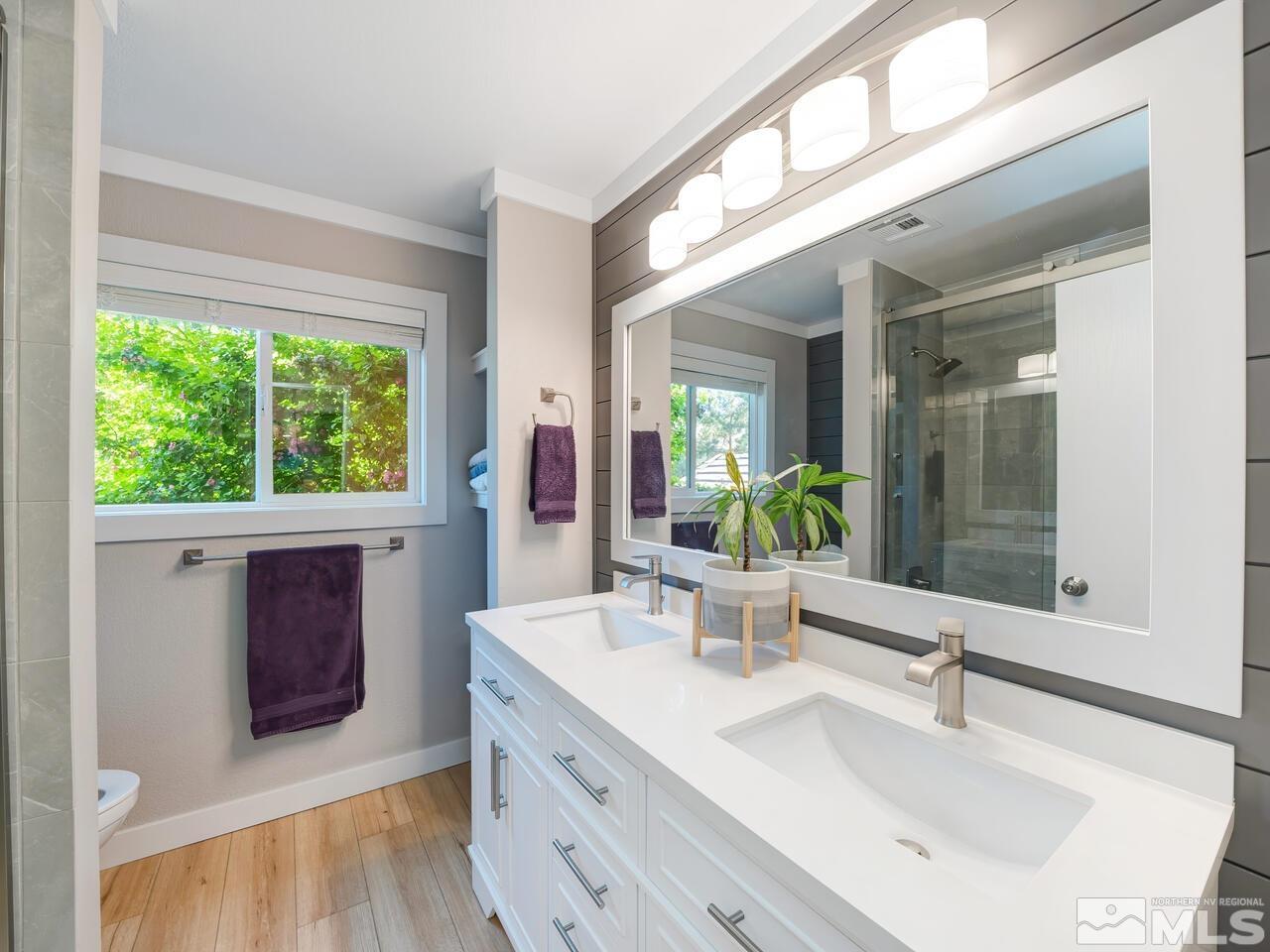 14555 Sundance Drive Reno, NV 89511 - Photo 30 of 40 a bathroom with a double vanity sink and mirror