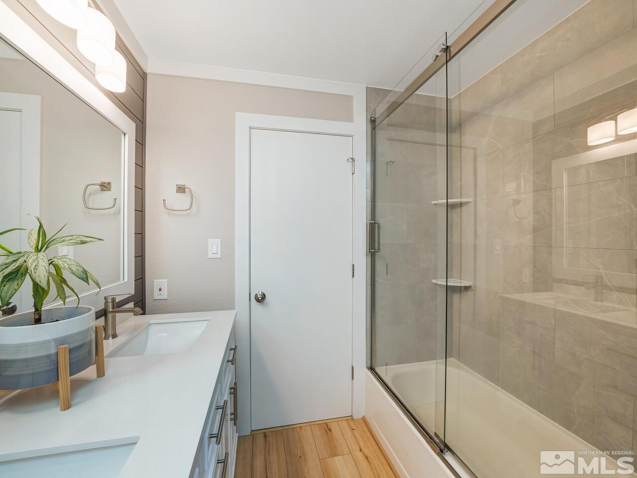 14555 Sundance Drive Reno, NV 89511 - Photo 31 of 40 a bathroom with a shower a mirror and a plant