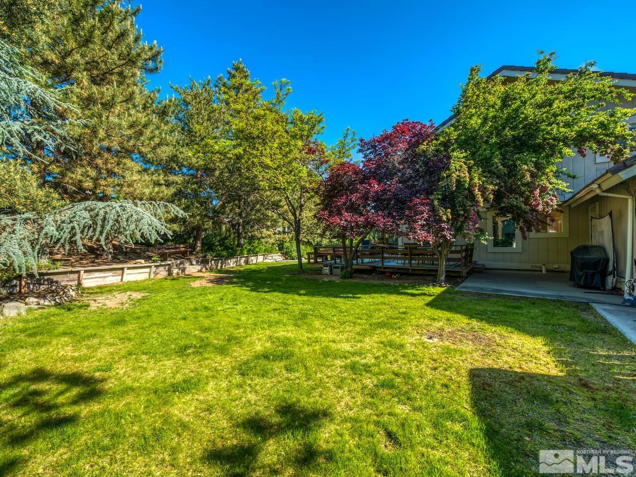 14555 Sundance Drive Reno, NV 89511 - Photo 33 of 40 a view of yard with swimming pool and green space