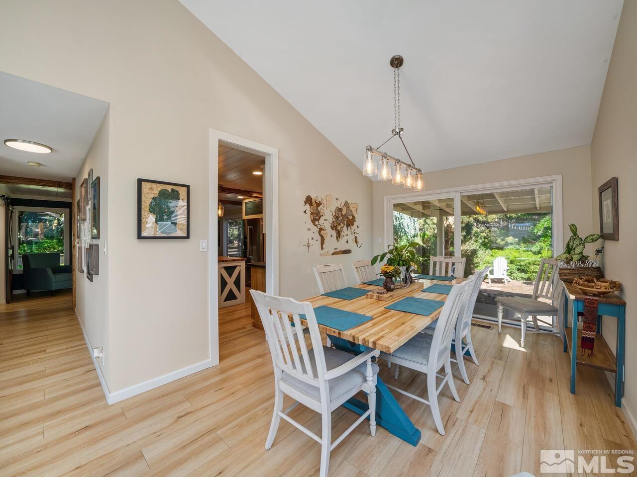 14555 Sundance Drive Reno, NV 89511 - Photo 9 of 40 a dining room with furniture a chandelier and wooden floor