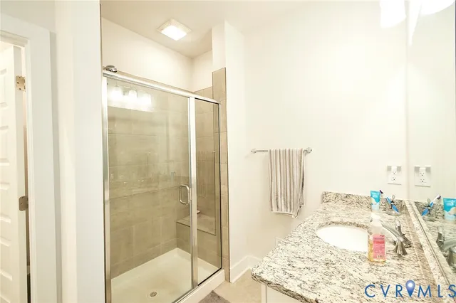 a bathroom with a shower and a sink