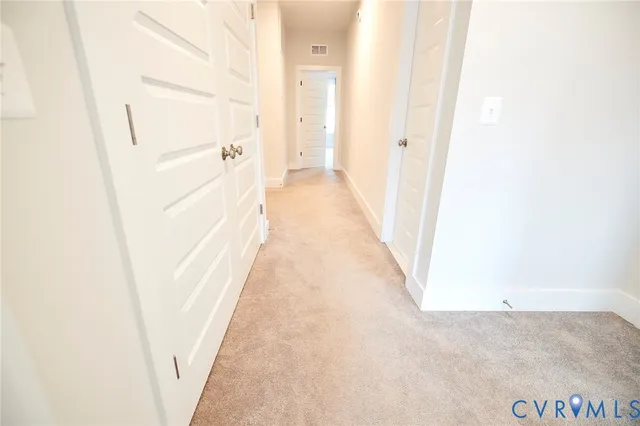 a view of a hallway with white walls
