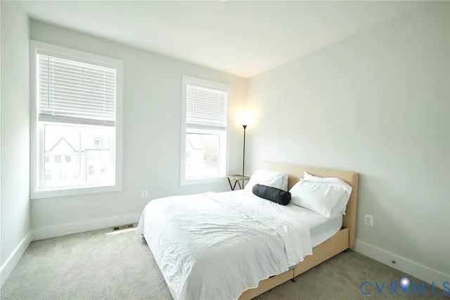 a bedroom with bed and window