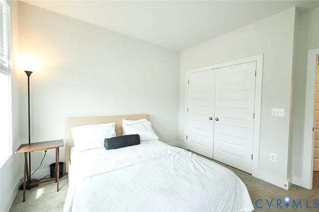 a bedroom with a bed and a chair