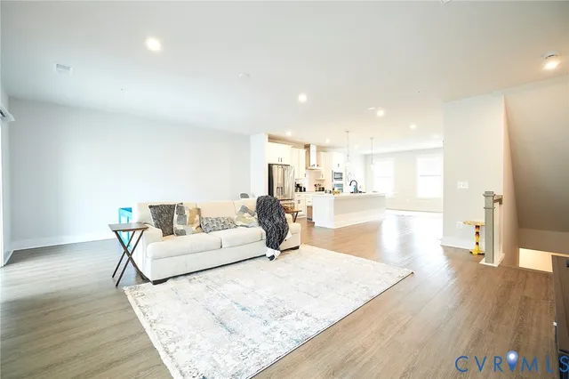 a living room with a couch and wooden floor