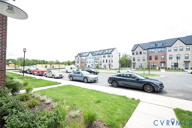 a cars parked in front of a house and a yard