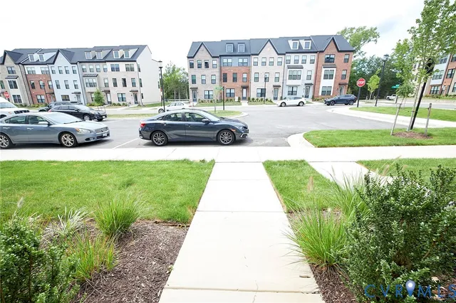 a car parked in front of a brick house with a yard