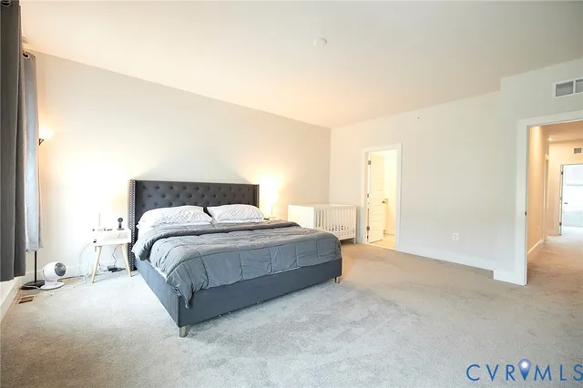 a spacious bedroom with a bed and a window