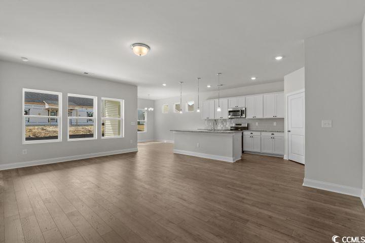 112 Furnies Place Conway, SC 29526 - Photo 3 of 24 Unfurnished living room with dark wood-type flooring, recessed lighting, and a chandelier