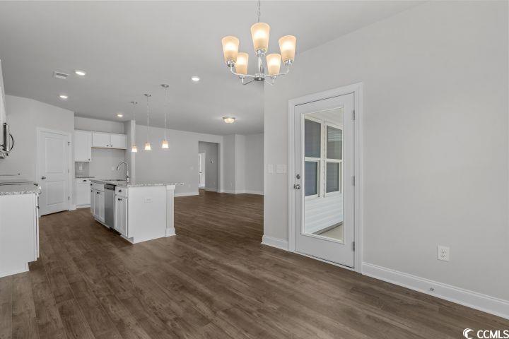112 Furnies Place Conway, SC 29526 - Photo 4 of 24 Kitchen with pendant lighting, a chandelier, dark wood finished floors, light stone counters, and recessed lighting
