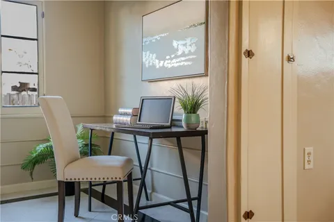 a view of a workspace with furniture and wooden floor