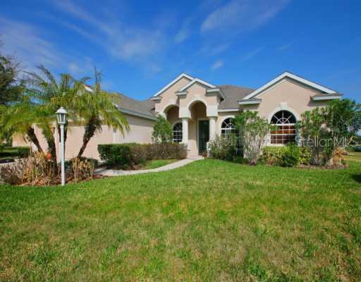11246 Rivers Bluff Circle Lakewood Ranch, FL 34202 - Photo 1 of 1 a front view of a house with a yard and potted plants