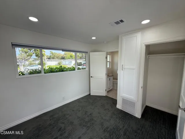 a bathroom with a granite countertop toilet a sink and a vanity