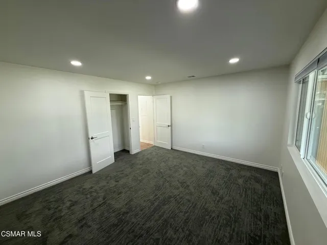 a bathroom with a granite countertop sink a mirror and a shower