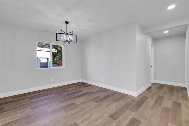 a view of wooden floor and windows in a room
