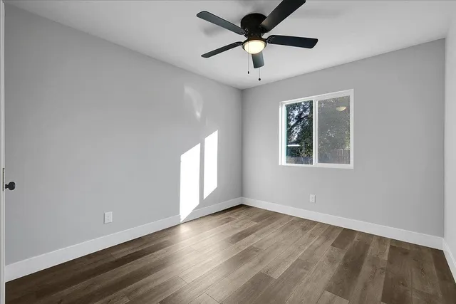 wooden floor in an empty room with a window