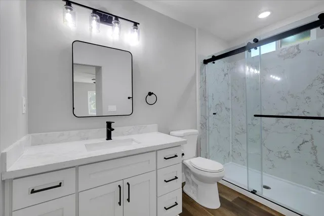 a bathroom with a toilet sink and shower