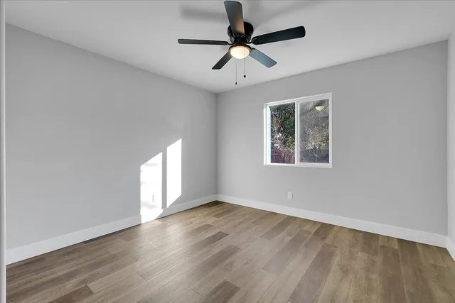 wooden floor in an empty room with a window