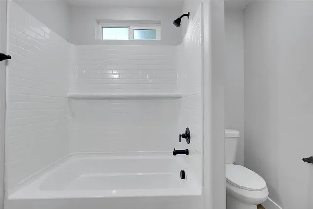 a bathroom with a bathtub and a toilet