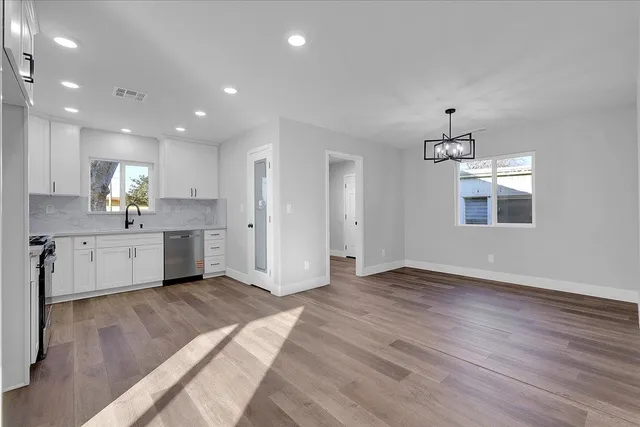 a view of kitchen with wooden floor electronic appliances and window