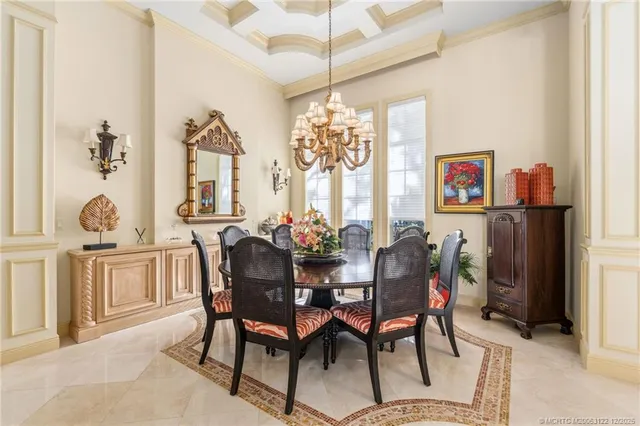 a view of a dining room with furniture and chandelier