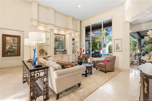a living room with furniture a dining table and a potted plant