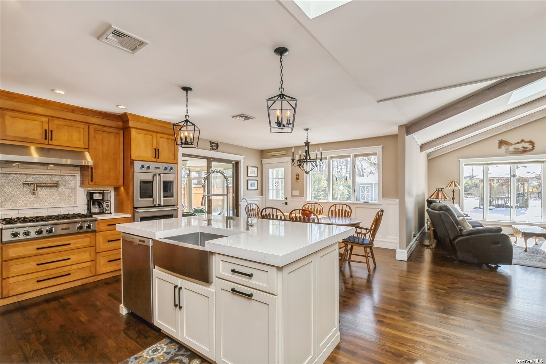 a open kitchen with stainless steel appliances granite countertop a stove and refrigerator