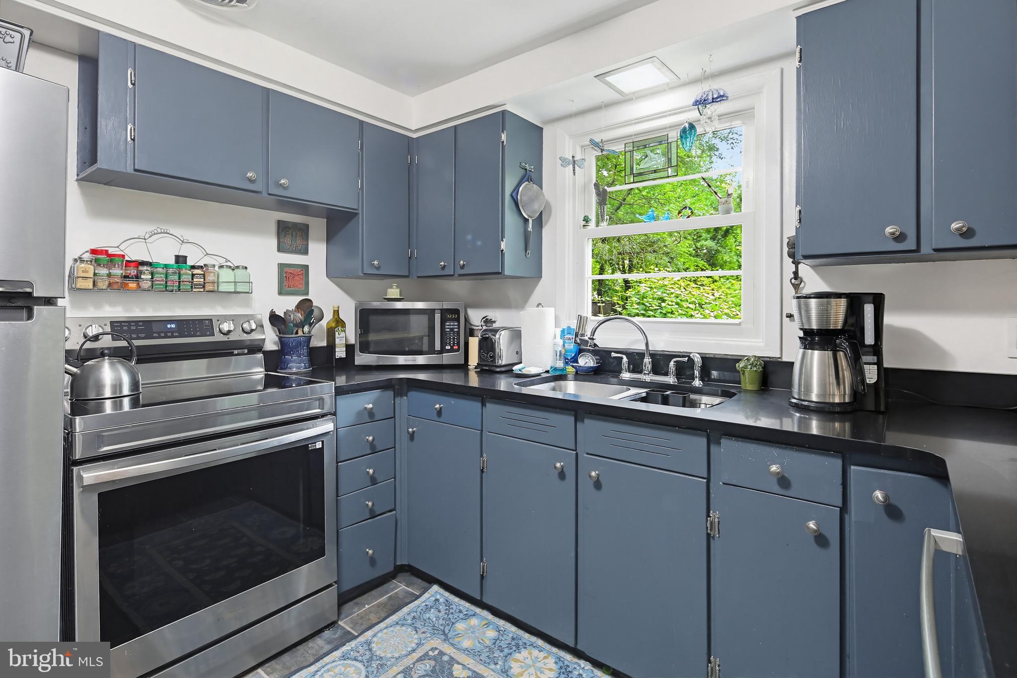 919 Blue Ridge Drive Annapolis, MD 21409 - Photo 22 of 30 a kitchen with granite countertop white cabinets and a window