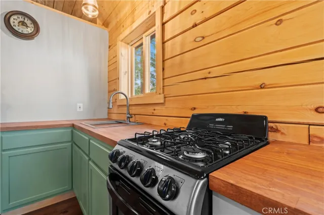 a stove top oven sitting inside of a kitchen