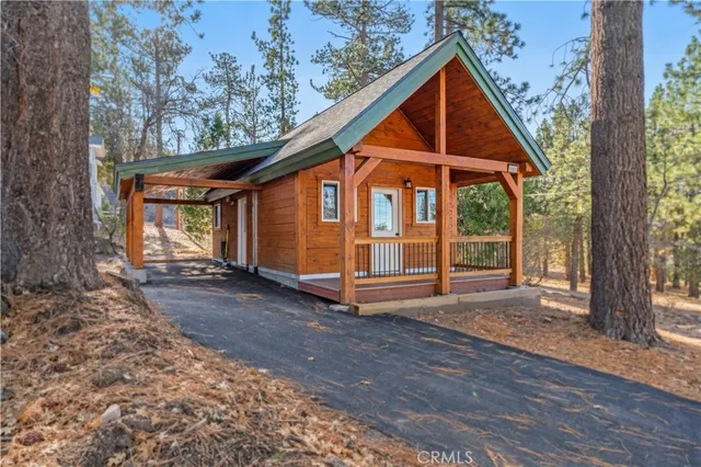 a view of a house with a yard and wooden fence