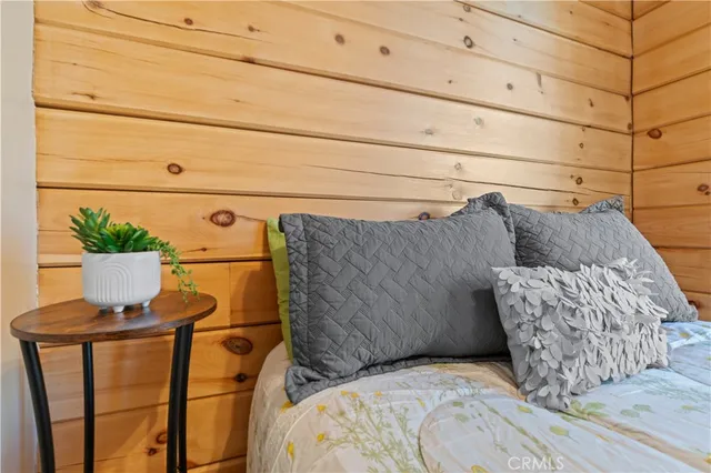 a bed room with a bed and chair