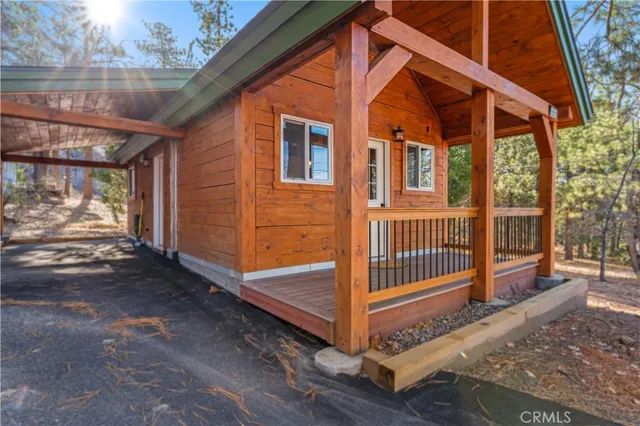 a view of a house with a small yard and wooden fence