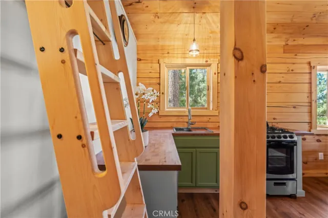 a kitchen with a sink and wooden floor