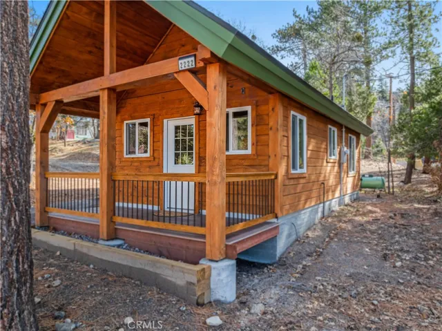 a view of a house with a yard and wooden fence