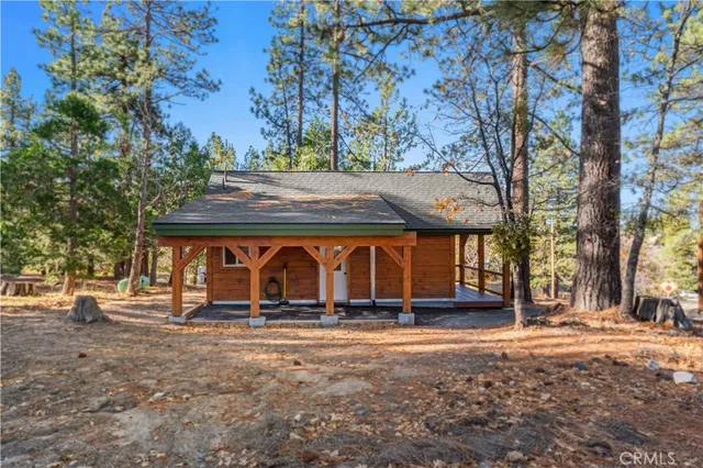 a view of house with a yard