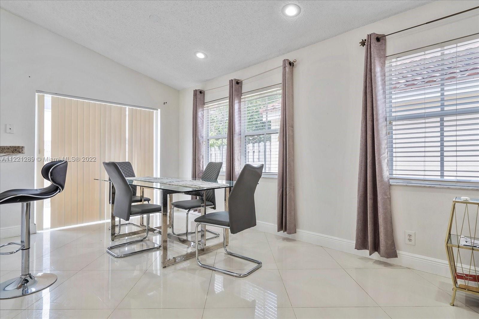 7384 Granada Way Margate, FL 33063 - Photo 11 of 30 a dining room with furniture and window