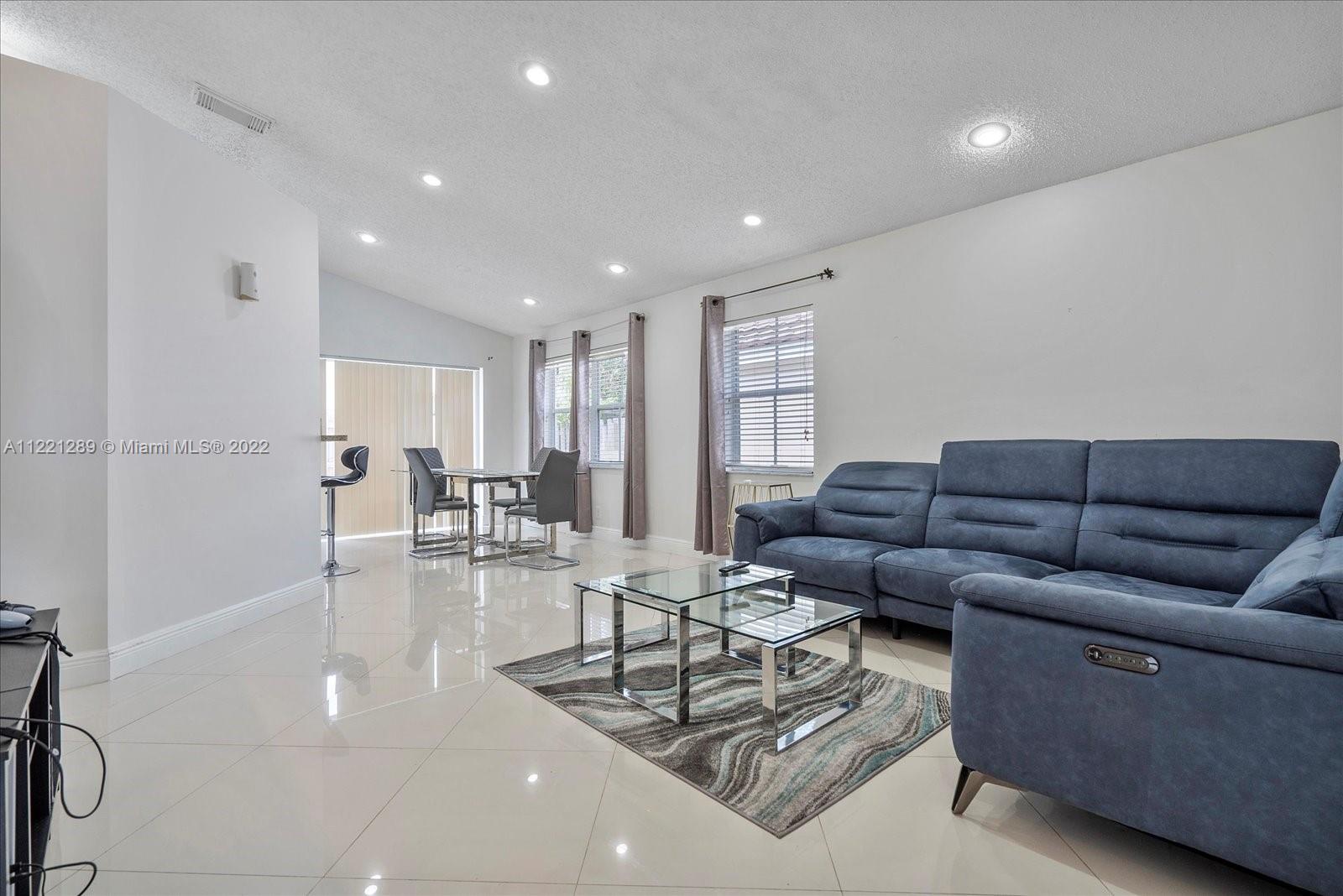 7384 Granada Way Margate, FL 33063 - Photo 12 of 30 a living room with furniture and a table with wooden floor
