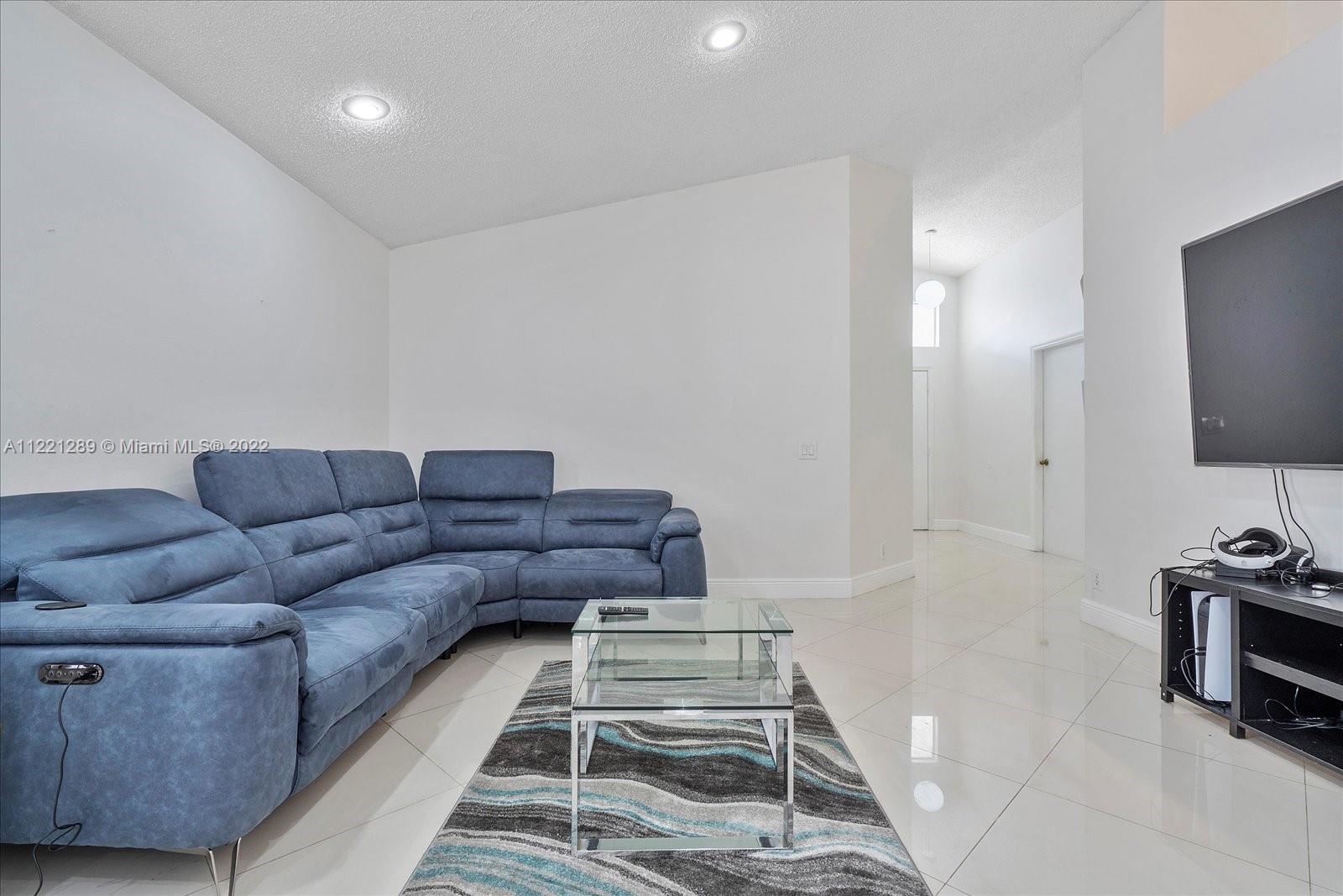 7384 Granada Way Margate, FL 33063 - Photo 13 of 30 a living room with furniture and a flat screen tv