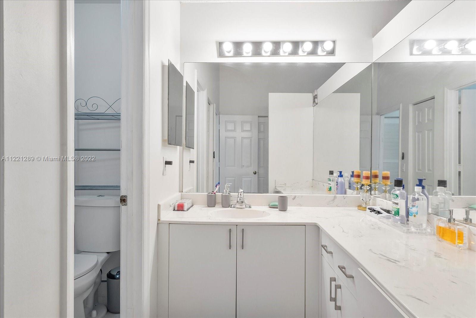 7384 Granada Way Margate, FL 33063 - Photo 15 of 30 a bathroom with a sink and a mirror