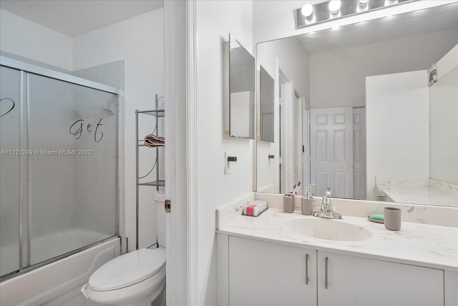 7384 Granada Way Margate, FL 33063 - Photo 18 of 30 a bathroom with a sink toilet and shower
