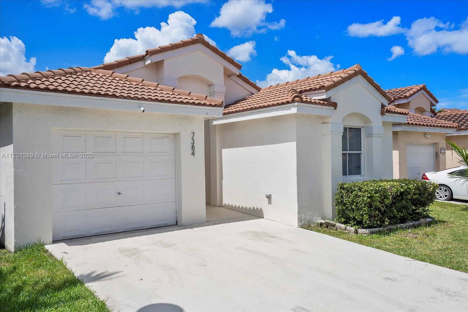 7384 Granada Way Margate, FL 33063 - Photo 2 of 30 a view of a house with a yard and garage