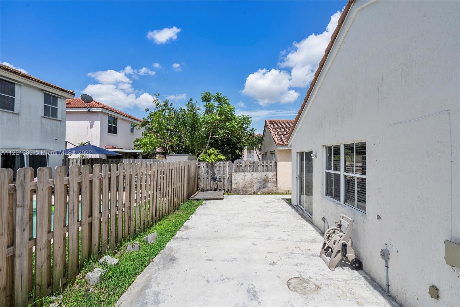 7384 Granada Way Margate, FL 33063 - Photo 29 of 30 a view of a house with wooden fence