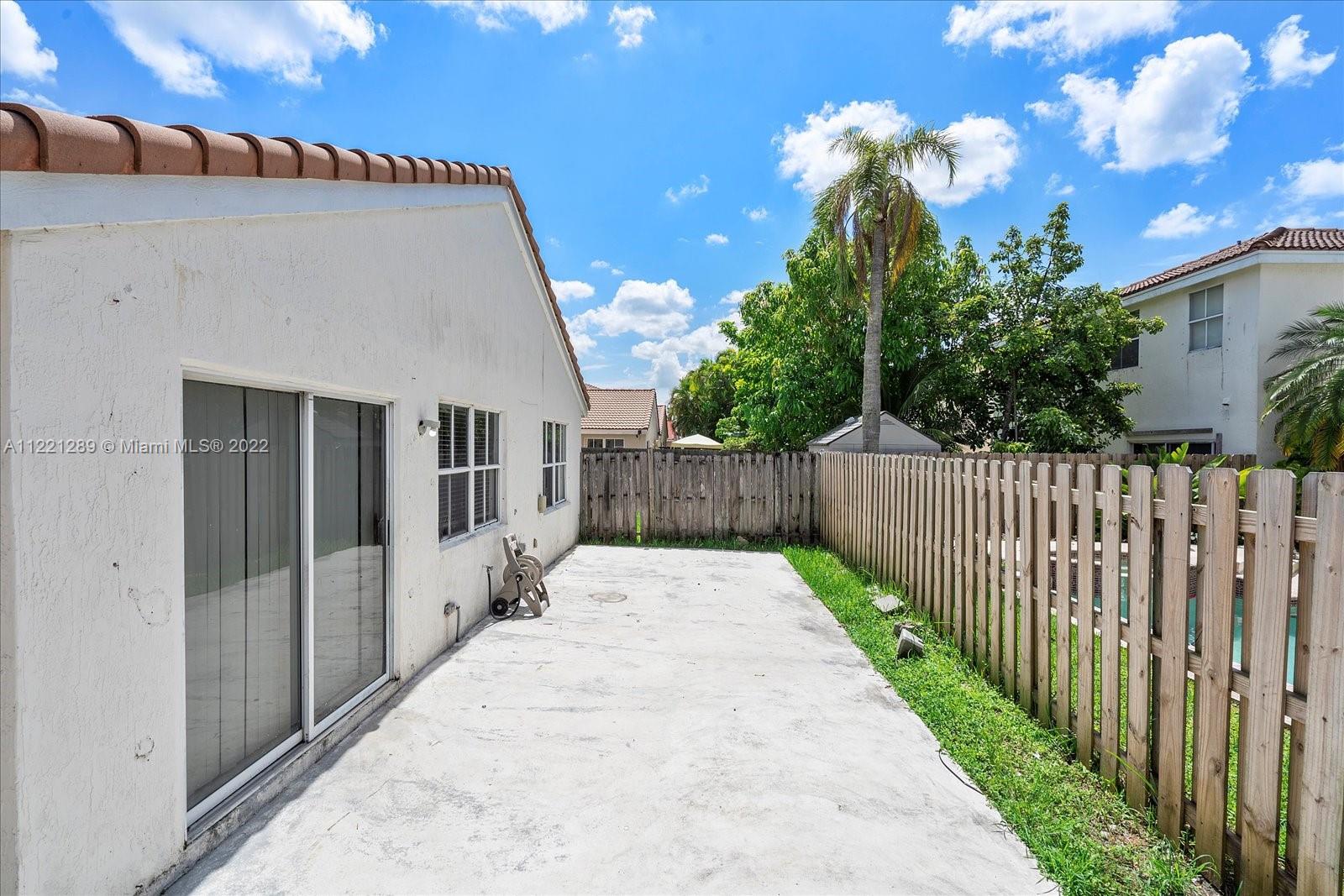 7384 Granada Way Margate, FL 33063 - Photo 30 of 30 a view of a house with wooden fence
