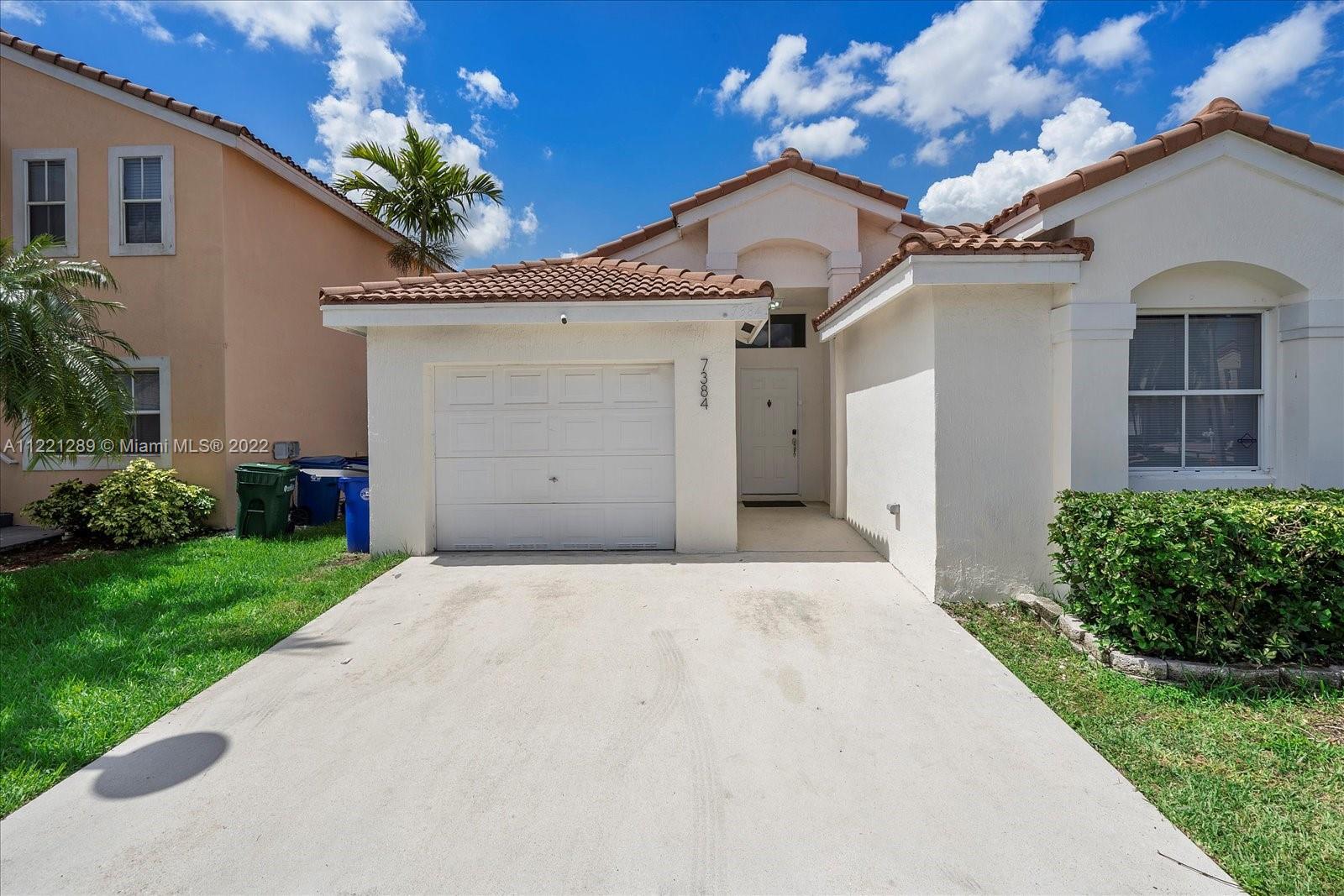 7384 Granada Way Margate, FL 33063 - Photo 4 of 30 a front view of a house with a yard and garage