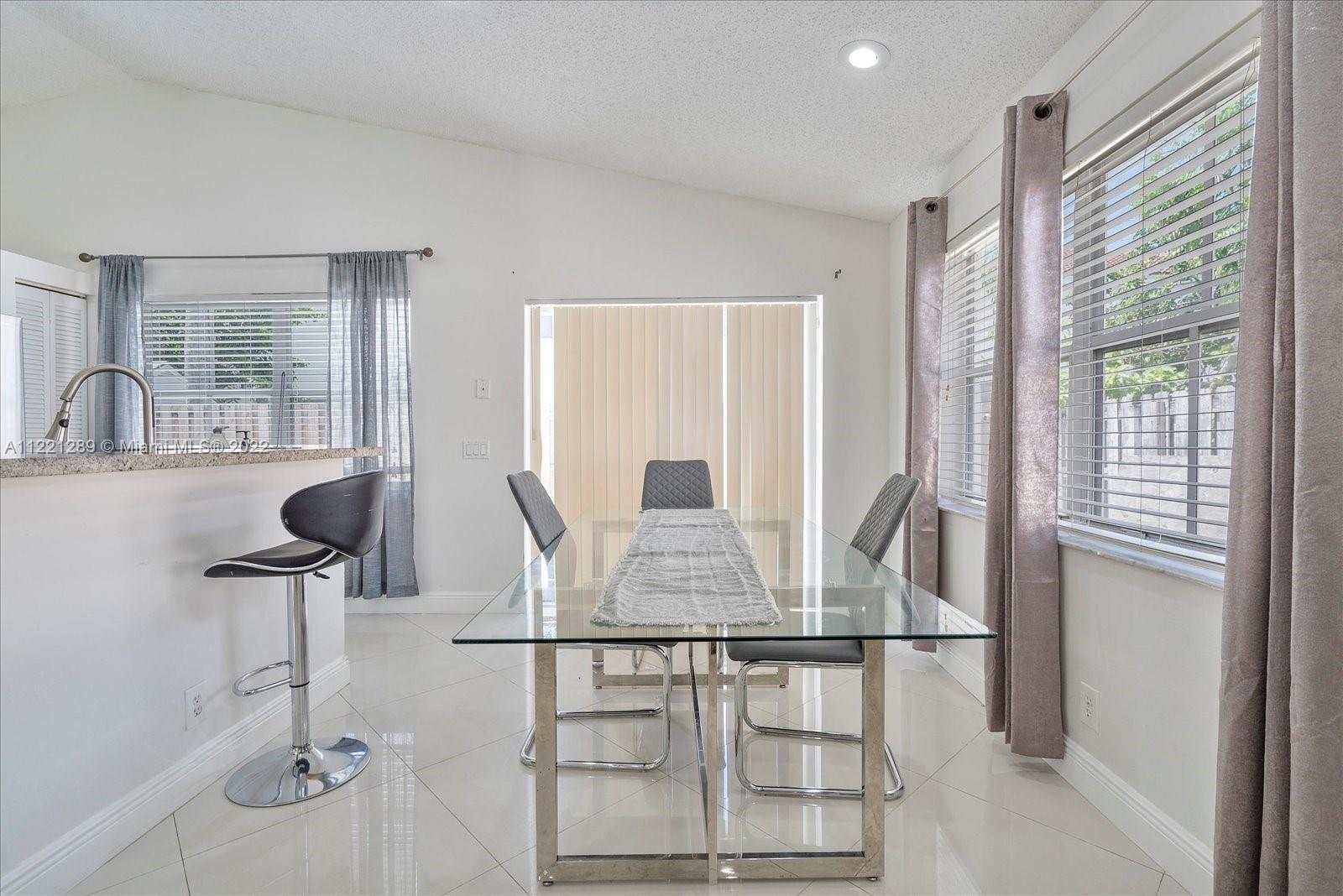 7384 Granada Way Margate, FL 33063 - Photo 10 of 30 a view of a dining room with furniture window and outside view