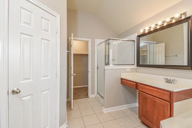 a bathroom with a sink vanity and a mirror