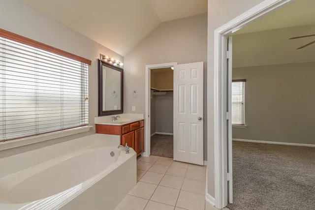 a bathroom with a bathtub and a shower